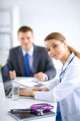 Fototapeta premium Medical team sitting at the table in modern hospital