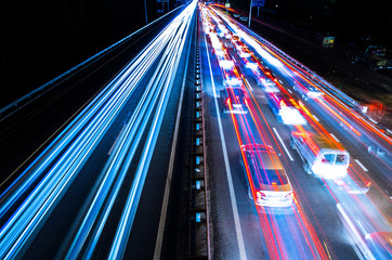 Fototapeta na wymiar Night traffic with blurred traces from cars