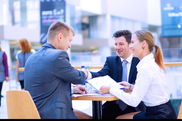 Group of happy young business people in a meeting at office