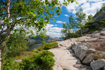 Norway, picturesque stony track in mountains framed with vegetat