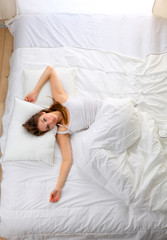 Obraz na płótnie Canvas Beautiful girl sleeps in the bedroom, lying on bed