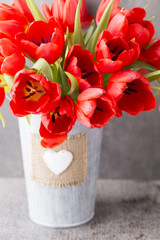 Red tulips on a wooden background.