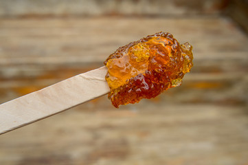 Maple taffy on a stick during sugar shack period
