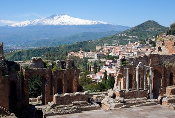 Ruins of the Greek Roman Theater in Taormina and
 volcano Etna, Sicily, Italy