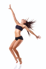 Fototapeta na wymiar Stylish and young modern style dancer jumping 