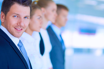 Smiling successful business team standing in office