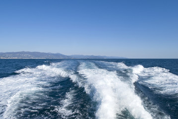 Waves on blue sea behind the boat