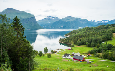 Small farm with red barn and white house in the Norwegian countr