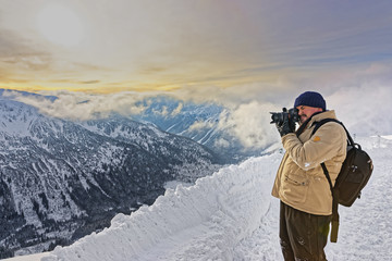 Fototapeta na wymiar Man taking photos in Kasprowy Wierch in Zakopane in Tatras