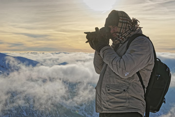 Fototapeta na wymiar Man taking photos on top of Kasprowy Wierch of Zakopane in winter