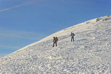 Fototapeta na wymiar People climbing atop of Kasprowy Wierch in Zakopane in winter