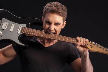 Obraz premium Skillful male young musician is making fun 