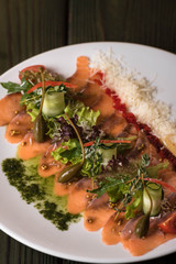 Salmon carpaccio with arugula and cheese