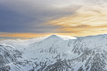 Fototapeta na wymiar Sun and clouds atop of Kasprowy Wierch of Zakopane on Tatras