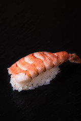 Nigiri sushi on a black background, Japanese cuisine