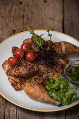Baked chicken in garlic sauce with cherry tomatoes and lettuce