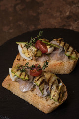Bruschetta with grilled zucchini and herring