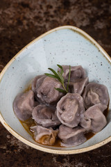 Ravioli with sauce and greens on a plate