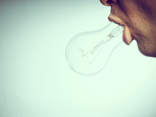 Caucasian man with bulb in his mouth