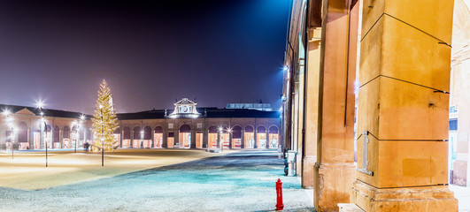 Christmas tree in square surrounded by loggias