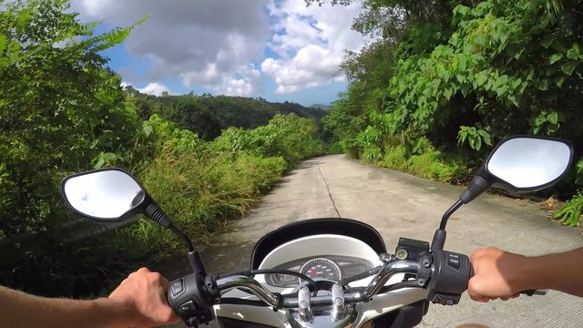 Driving a Motorbike on Tropical Island Road in Jungle. 2.7K