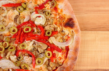 Italian vegetarian pizza on wooden surface