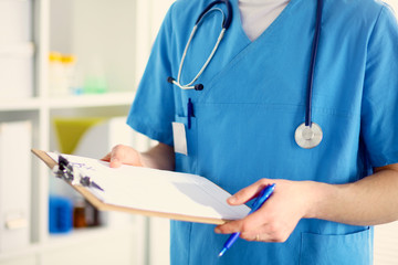 Closeup portrait of a  doctor with stethoscope holding folder