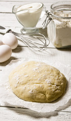 Preparation of the dough. The prepared dough with the ingredients - eggs, flour, sour cream and whisk .