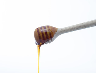 Closeup Wooden Honey Stick on White background
