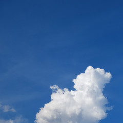 large cumulus cloud on clear blue sky background