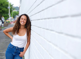 Cheerful young woman standing outdoors