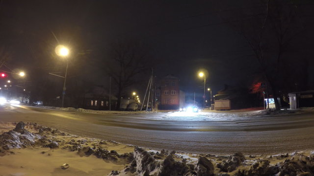 Cars going on street at winter night. Time lapse.