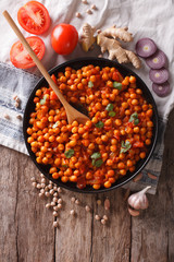 Indian Chana masala with ingredients. Vertical top view
