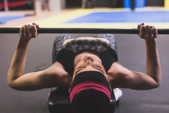 Beautiful girl doing workout in the gym