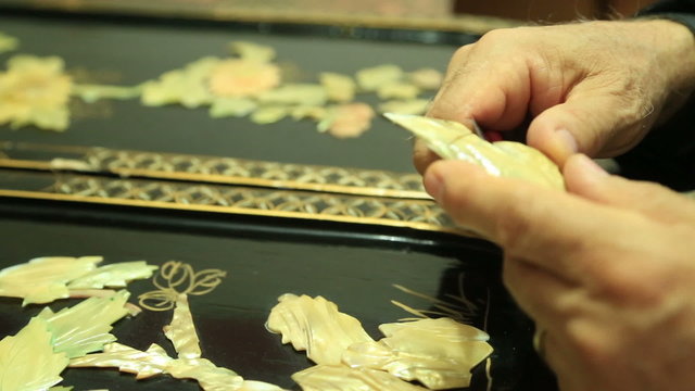 Traditional nacre craftsman working  with floral motifs