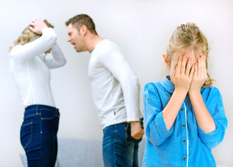 Parents quarreling at home, child is crying.