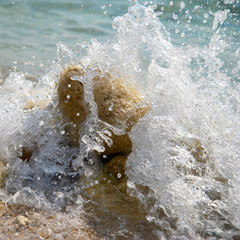 Sea rocks in the waves with sea foam