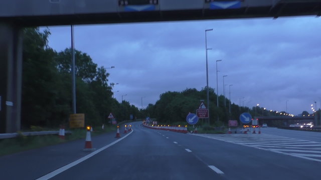Driving through the junction 2 and exit off Manchester ringroad M60 by Stockport early in the morning, one lane closed using flashers on cones