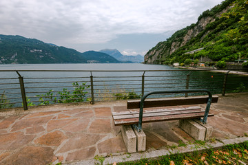 Naklejka na ściany i meble a bench near Como lake. Selective focus. Varenna on Como lake in Italy, Alps, Europe.