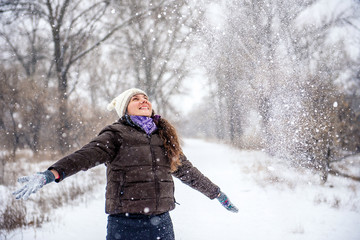Young woman throwing snow 