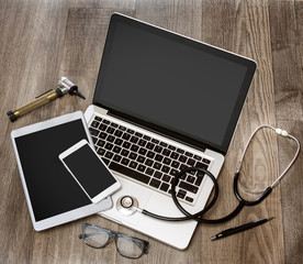 Wood doctor's desk in high definition with laptop, tablet and mo