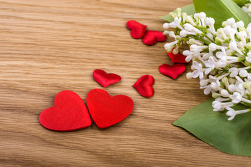 White lilac and hearts on  wooden background