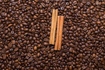 coffee beans and cinnamon on the table the whole texture of coarse brown lot