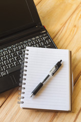 Pen, Blank notepad and laptop on the office.