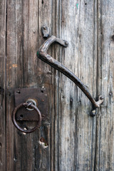 old wooden door with wrought iron handle