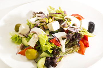 Greek salad on a white background in the restaurant