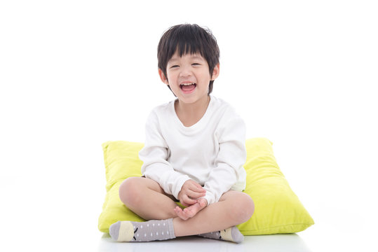 Happy asian boy sitting