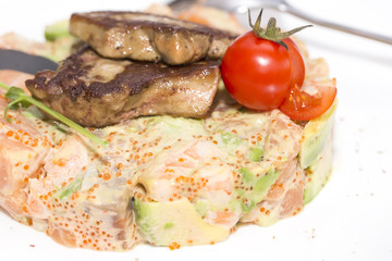 salad, fish and eggs decorated with greens and tomatoes