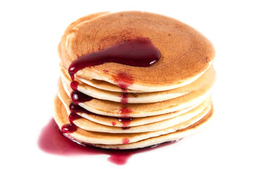 Stack of pancakes isolated on white with syrup