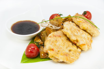 shrimp patties of meat with a salad of eggplant on a white background in restorne